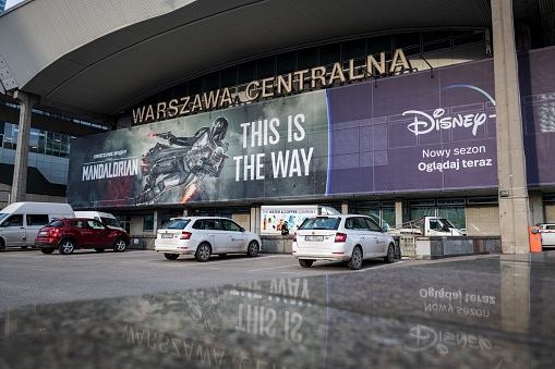 Warsaw, Poland - March 15, 2023: On the side of Warsaw Central station, a large banner advertises the the movie The Mandalorian, made for the streaming service Disney+.