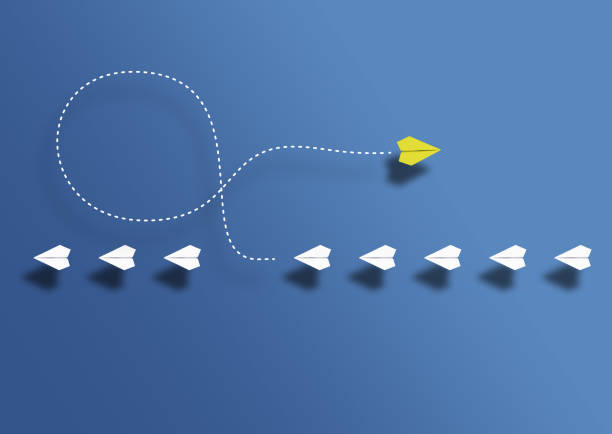 istock paper planes in a row and one paper glider going in opposite direction above blue background 1475039746