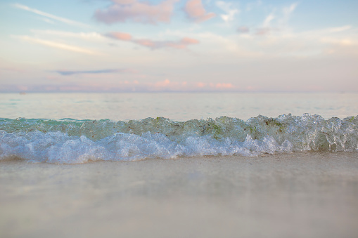 Beach waves with pastel colored sky.