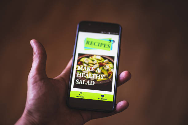 hand holding phone . online cooking blog