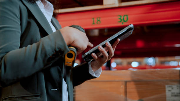 istock Young Asian Staff from Trading Company Taking Stocks Using Digital Tablet and Barcode Scanner. 1475041082
