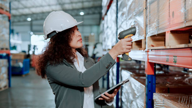 istock Young Asian Warehouse Inspector Counting Inventory with Digital Tablet and Laser Scanner. 1475041112