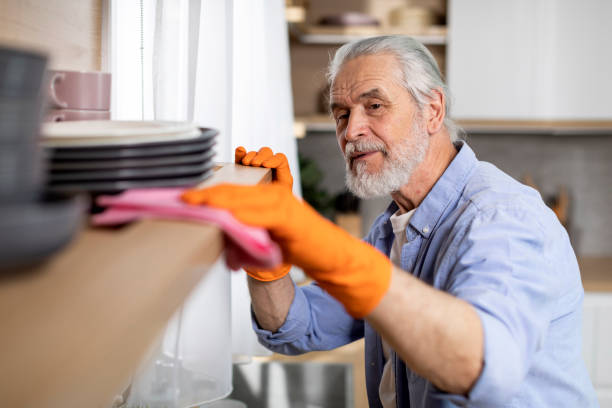 istock OCD Concept. Senior Man Cleaning Dust From Shelf In Kitchen 1475041179