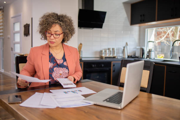 istock Mature woman going through paperwork 1475042318