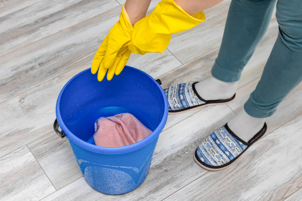 istock man puts on gloves before cleaning the room 1475044322
