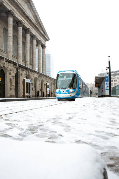 eine west midlands tram auf den straßen von birmingham mit winterschnee - town hall uk birmingham city street stock-fotos und bilder