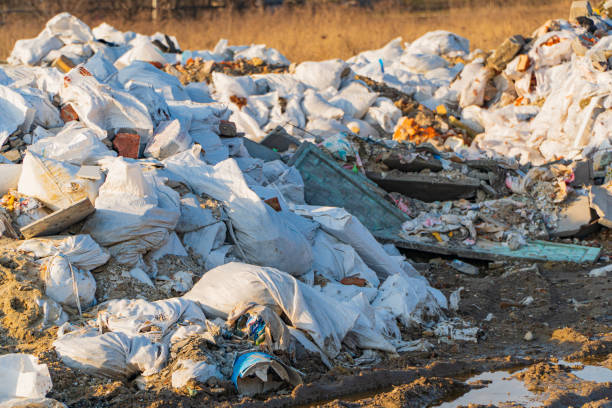 istock Garbage Dumping Area. Garbage dump with plastic bags and food waste. Trash disposal area 1475046524