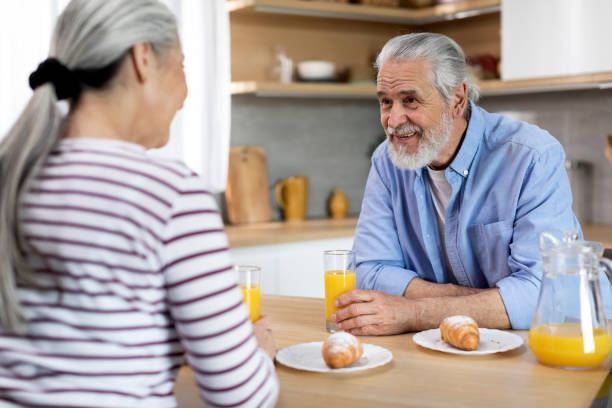istock Senior Married Couple Chatting While Having Breakfast Together In Kitchen 1475048912
