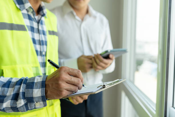 istock inspector engineer and owner project is inspecting construction and quality assurance new house. Engineers or architects or contactor work to build the house before handing it over to the homeowner 1475048913