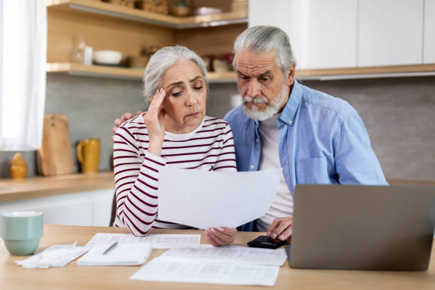 istock Upset Senior Spouses Reading Papers While Calculating Family Budget In Kitchen 1475048916