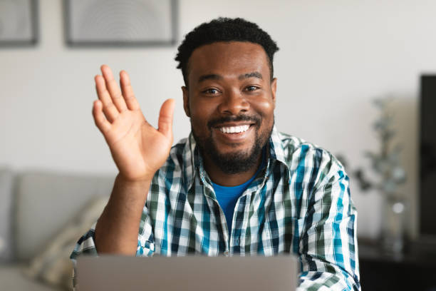 istock Black Freelancer Guy Waving Hand To Laptop Video Calling Indoor 1475048951