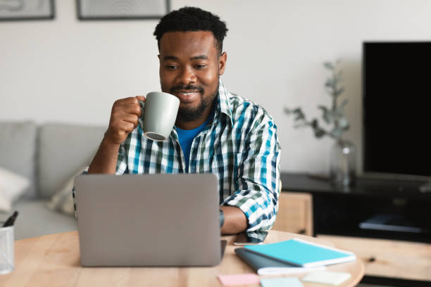 istock Successful African American Man Working On Laptop Computer At Home 1475048953
