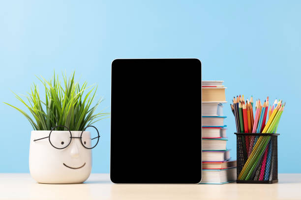 istock Tablet with colorful pencils and stack of books 1475049156