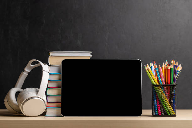 istock Tablet with colorful pencils and stack of books 1475049180