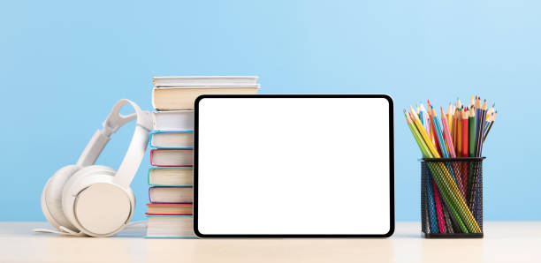 istock Tablet with colorful pencils and stack of books 1475049254