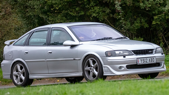 Stony Stratford,Bucks,UK - October 23rd 2021. 2001 silver Vauxhall Vectra classic car driving on an English country road