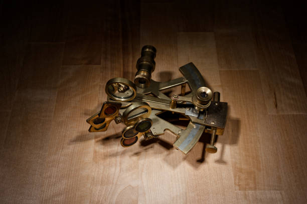istock old sextant, spyglass, circle and compass lying on wooden table 1475052939