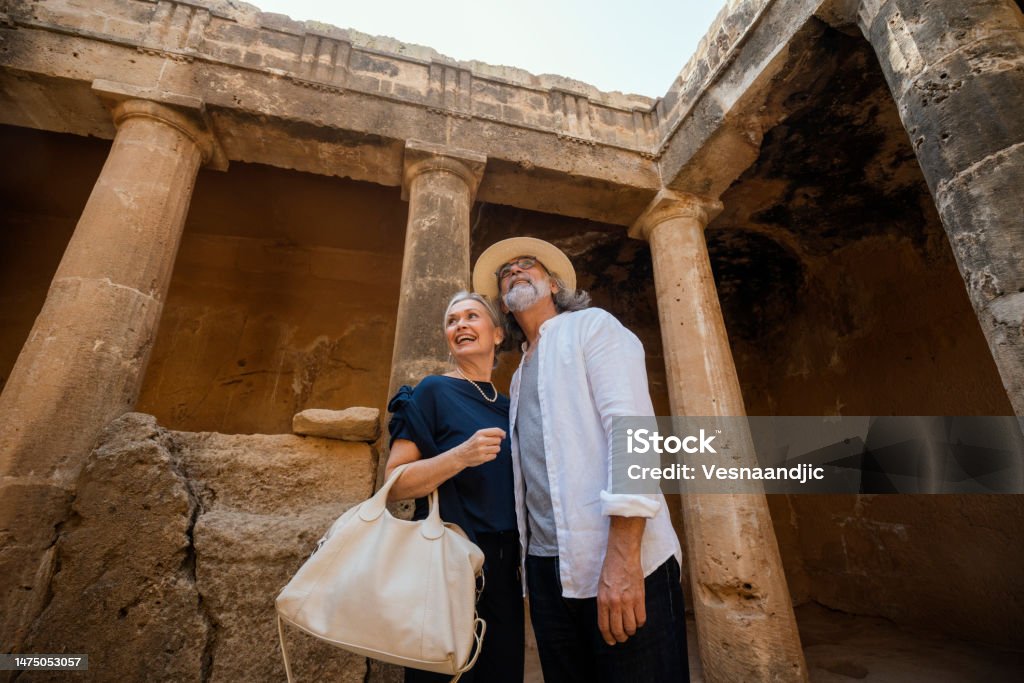 Mature couple visiting Cyprus, tombs of the kings necropolis on Paphos Ancient Stock Photo