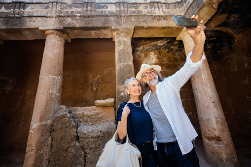 Mature couple visiting Cyprus, tombs of the kings necropolis on Paphos
