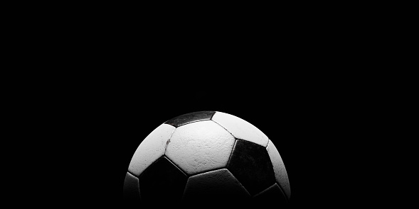 Football or Soccer with spotlight and fade-out shadow in the dark background. Copy space. Sport and game concept. 3D illustration rendering