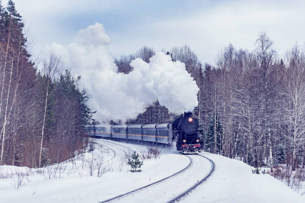 istock Retro steam train moves at winter time. 1475054589