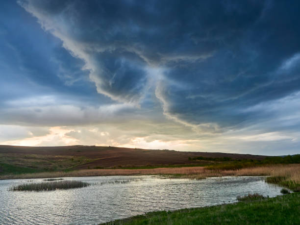 Rain storm over a lake, view of dark clouds moving.