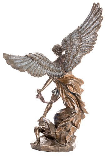 Archangel Michael bronze statue isolated on white background. Vertical shot. Back view.