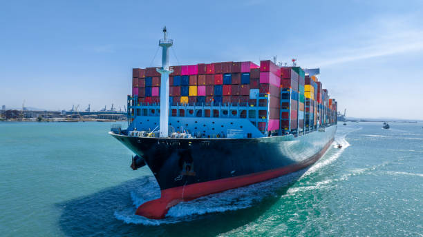 istock Aerial in front view of cargo ship carrying container and running for export goods from cargo yard port to custom ocean concept technology transportation , customs clearance. 1475056044