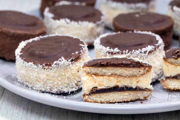 Chocolate candies with milk coconut filling and coconut chips stock photo