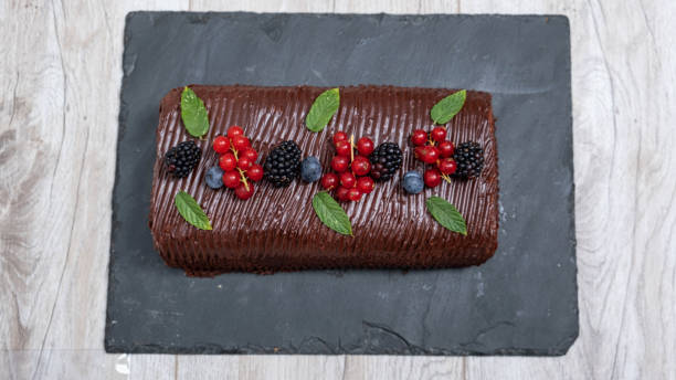 Homemade Chocolate and fruit roll cake stock photo