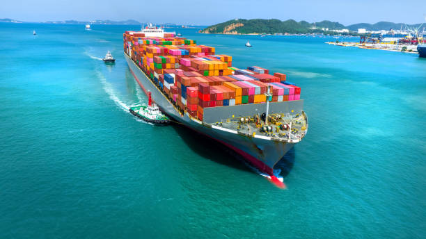 istock Aerial in front view of cargo ship carrying container and running for export goods from cargo yard port to custom ocean concept technology transportation , customs clearance. 1475057331