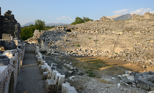 Tlos held high prestige among the Lycian cities due to its geographic location, which is 42 km east of Fethiye. The ancient settlement is in the Yaka village, where village life and the ruins of the ancient city blend together. The settlement is reached by an asphalt road from the east via the Güneşli village, on the way to Saklıkent after the Seydikemer district. The settlement of Tlos starts from the western slopes of Akdağlar (Kragos) and continues to the plains composed of alluvium carried by the Eşen River (Xanthos).