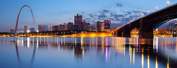 City of St. Louis skyline. Panoramic image of St. Louis downtown with Gateway Arch at twilight. This is composite of two horizontal images stitched together in photoshop. mississippi river stock pictures, royalty-free photos & images