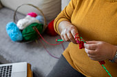 istock Knitting and watching tutorials 1475059415