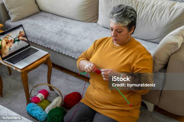 Knitting And Watching Tutorials Stock Photo - Download Image Now - Laptop, Mature Adult, Adult