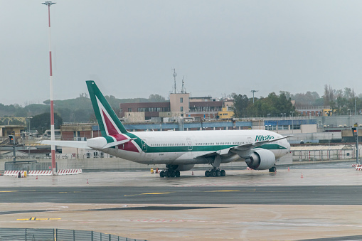 Fiumicino, Italy - December 9, 2022: Alitalia Boeing 777-243(ER) at Leonardo da VinciFiumicino Airport.