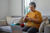 istock Knitting and watching tutorials 1475060007