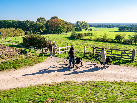 Senior bicyclists and walkers in nature near town of Ootmarsum, Overijssel, Netherlands