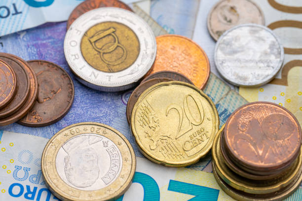 istock Assortment of coins on bank notes from different countries.. 1475061431