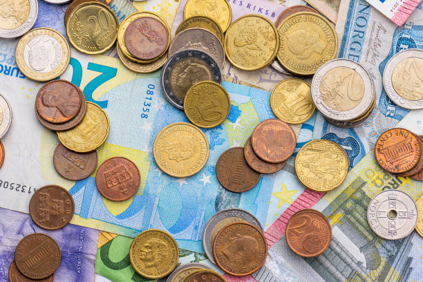 istock Assortment of coins on bank notes from different countries.. 1475061435