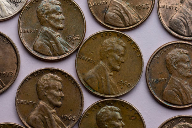 istock Old cent coins on purple background.. 1475061471