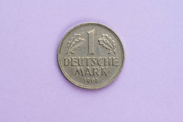 istock One german Mark coin marked 1 Deutsche Mark from 1968 on purple background.. 1475061507