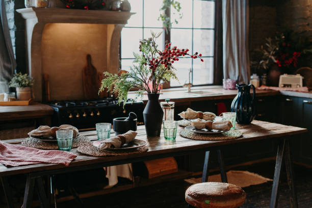 istock Indoor shot of served table with rolled napkins. Dinner time concept. Table setting decor. Interior of home kitchen. Rustic serving 1475061555