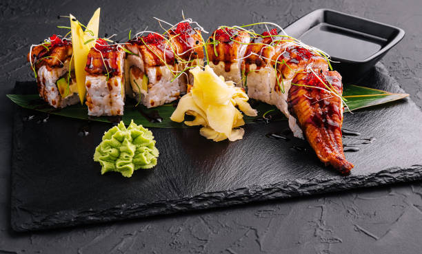 istock Canadian roll with eel, cheese cream and avocado on black 1475063556