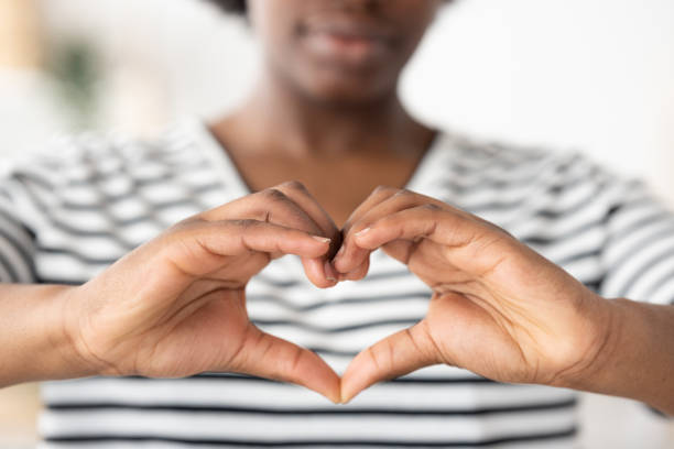istock Closeup of hands making love sign 1475063830