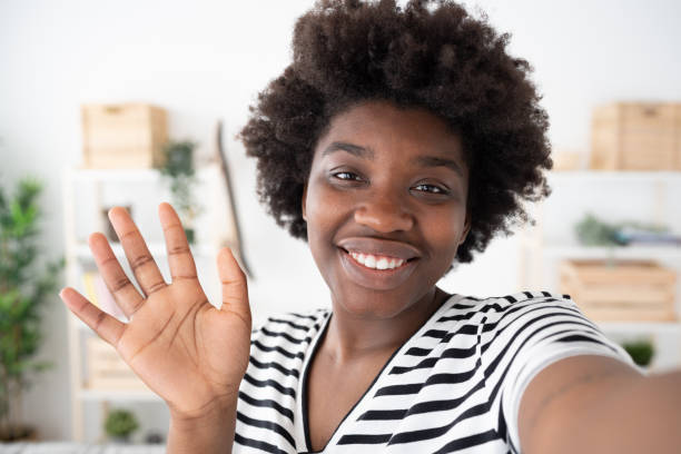 istock Black woman greeting to camera 1475063854