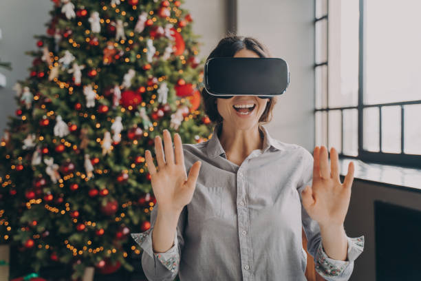 istock Impressed europian lady using VR googles while spending Christmas at home 1475065681