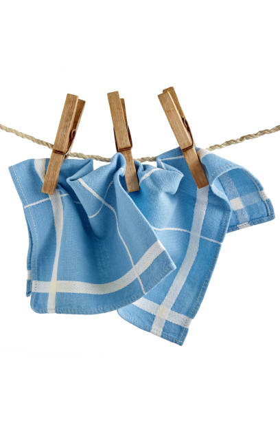 istock Blue kitchen napkin hangs on clothespins isolated on white background 1475065758