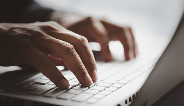 istock Man hand working on the laptop in office with the fair light shines through. 1475065933
