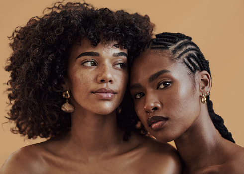 Portrait of attractive models with diverse skin tones posing for beauty, skin and makeup. Natural skincare, hair care and makeup.